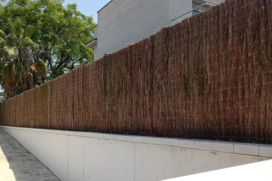 Cerramiento de terraza en Boadilla del Monte con brezo natural de alta densidad instalado sobre una valla para mejorar la privacidad.